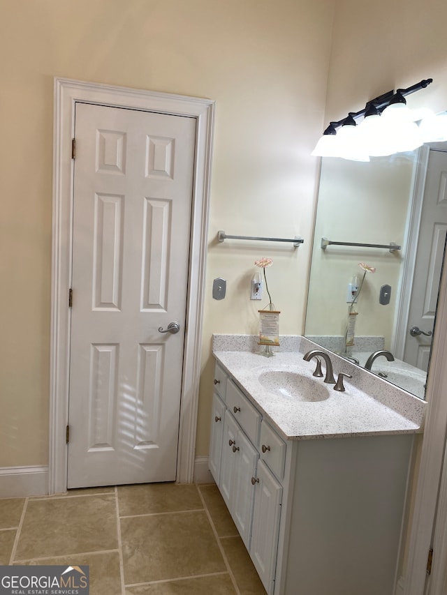 bathroom with tile patterned flooring and vanity