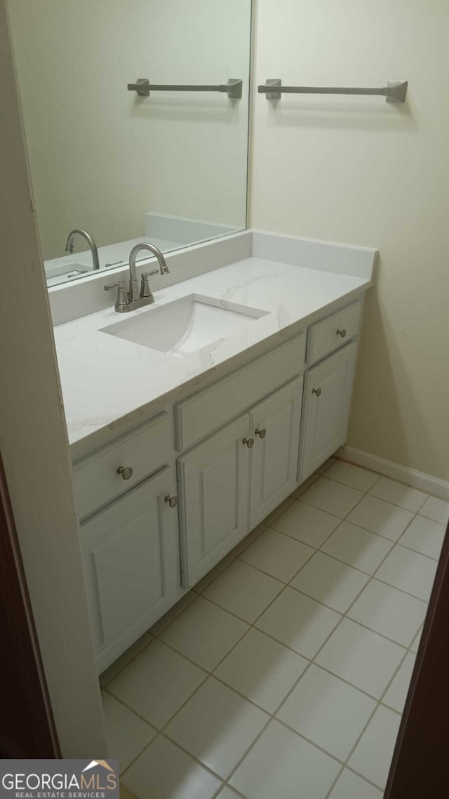 bathroom featuring tile patterned flooring and vanity