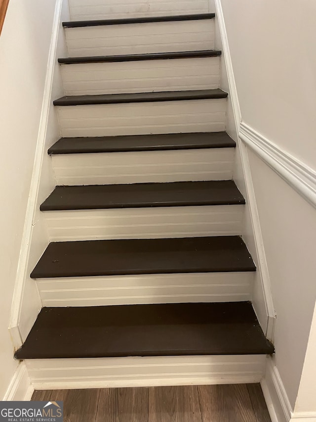 staircase with hardwood / wood-style floors