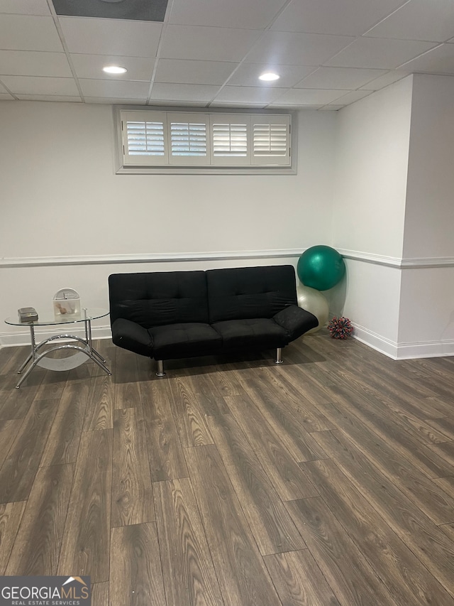 sitting room with a paneled ceiling, plenty of natural light, and dark hardwood / wood-style floors