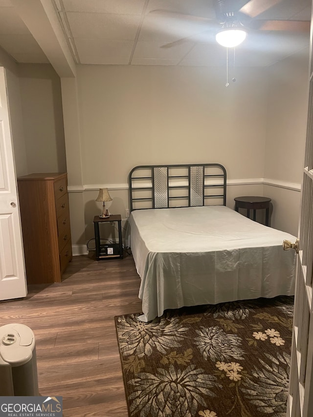 bedroom with ceiling fan and dark wood-type flooring