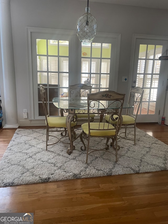 dining room featuring hardwood / wood-style flooring and a wealth of natural light