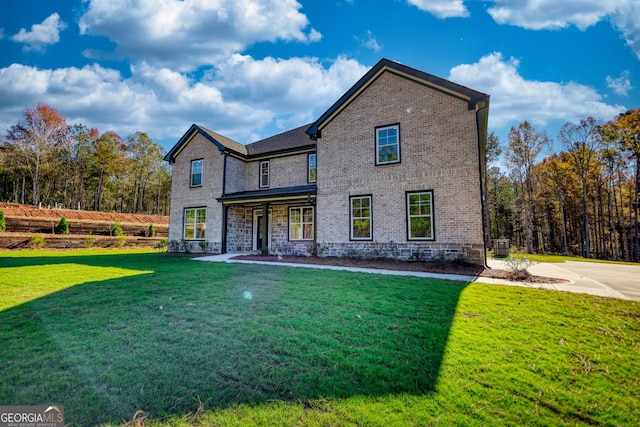 view of front of home featuring a front yard, brick siding, and central AC unit