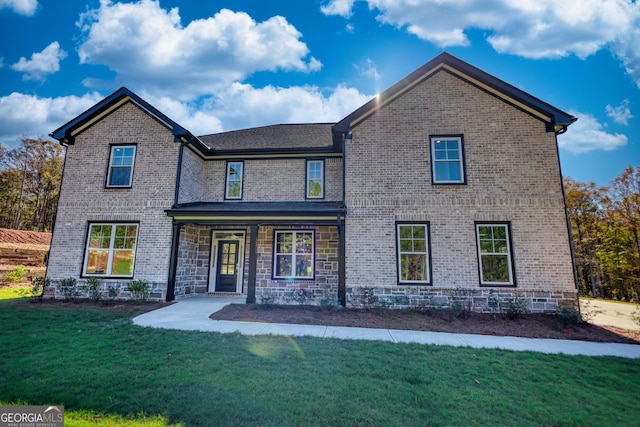 traditional home featuring brick siding and a front lawn