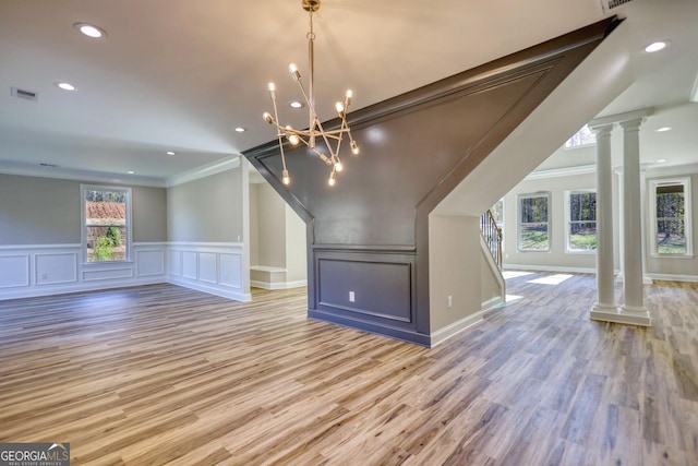 bonus room featuring light wood-style floors, visible vents, and decorative columns