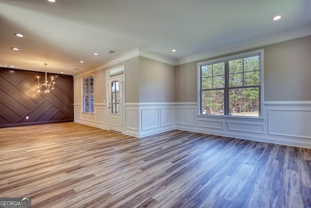 interior space featuring light wood finished floors, a notable chandelier, and recessed lighting