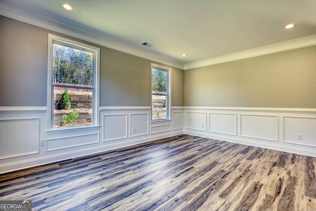 unfurnished room featuring visible vents, ornamental molding, wood finished floors, and recessed lighting