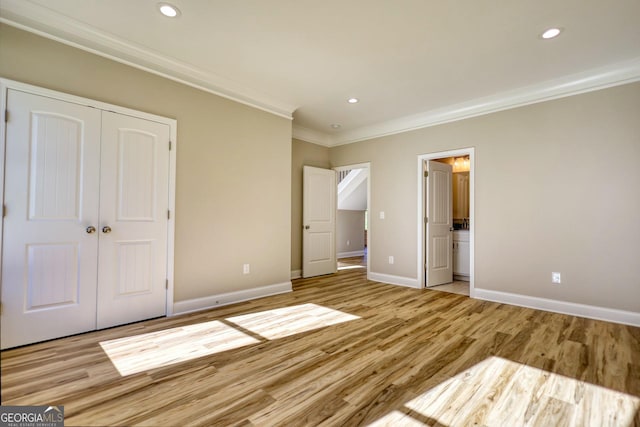 unfurnished bedroom with baseboards, a closet, light wood-style flooring, and crown molding