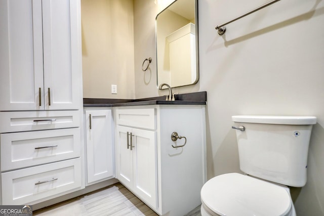 bathroom featuring toilet and vanity