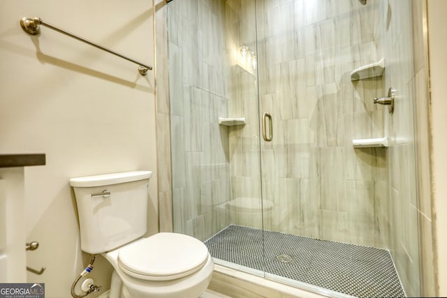 full bath featuring a stall shower and toilet