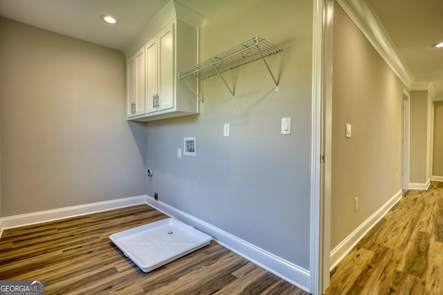 laundry area featuring washer hookup, cabinet space, hookup for an electric dryer, wood finished floors, and baseboards