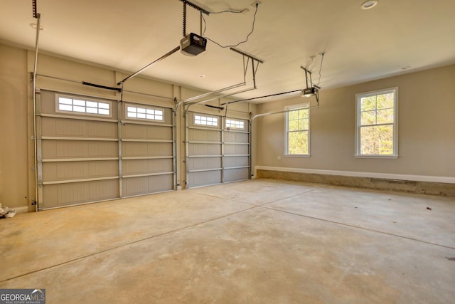 garage with baseboards and a garage door opener