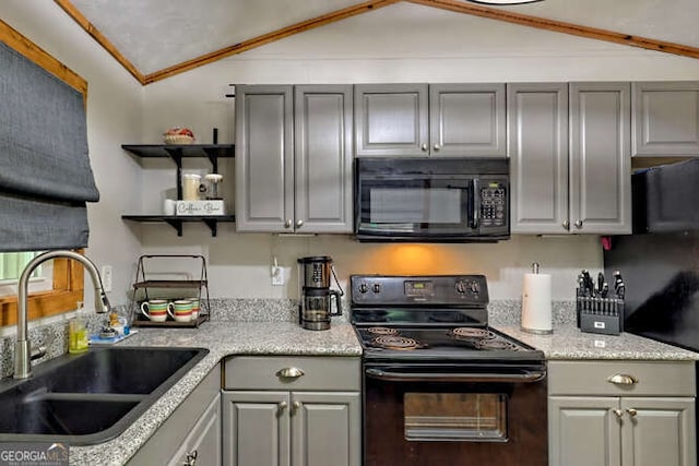 kitchen with sink, gray cabinets, lofted ceiling, and black appliances