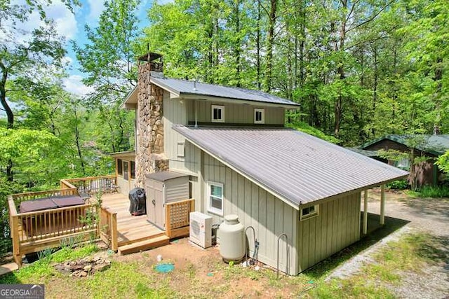 rear view of house featuring a wooden deck