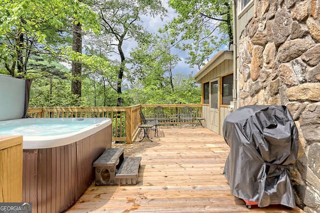 wooden terrace featuring a hot tub