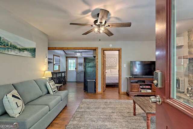 living room featuring hardwood / wood-style flooring and ceiling fan