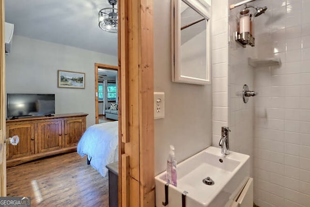 bathroom with a shower, wood-type flooring, and sink