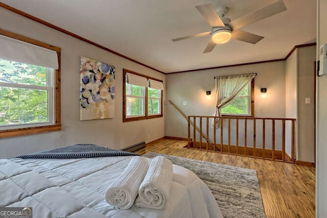 bedroom featuring multiple windows, ceiling fan, and light wood-type flooring