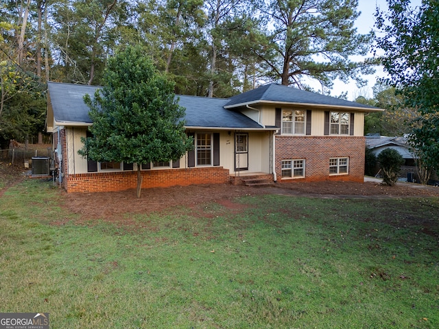 split level home featuring central AC unit and a front lawn