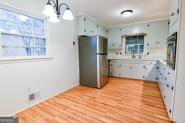 120 Tara Way, Athens, GA 30606 - kitchen featuring freestanding refrigerator, a sink, light wood-style floors, and plenty of natural light