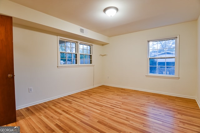 spare room with light hardwood / wood-style flooring