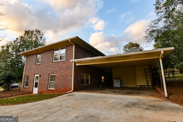 property exterior at dusk with a carport