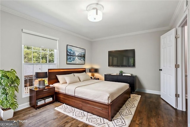 bedroom featuring ornamental molding, baseboards, and wood finished floors