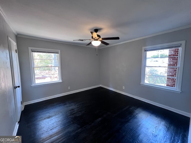 empty room featuring ceiling fan, a healthy amount of sunlight, dark hardwood / wood-style flooring, and ornamental molding