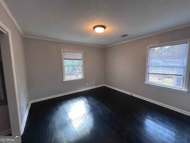 unfurnished room with crown molding and dark wood-type flooring