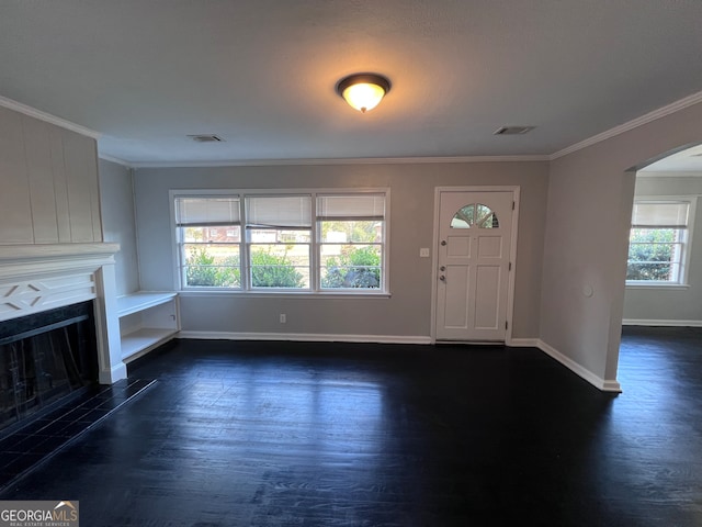 foyer entrance featuring crown molding, dark hardwood / wood-style flooring, and a healthy amount of sunlight