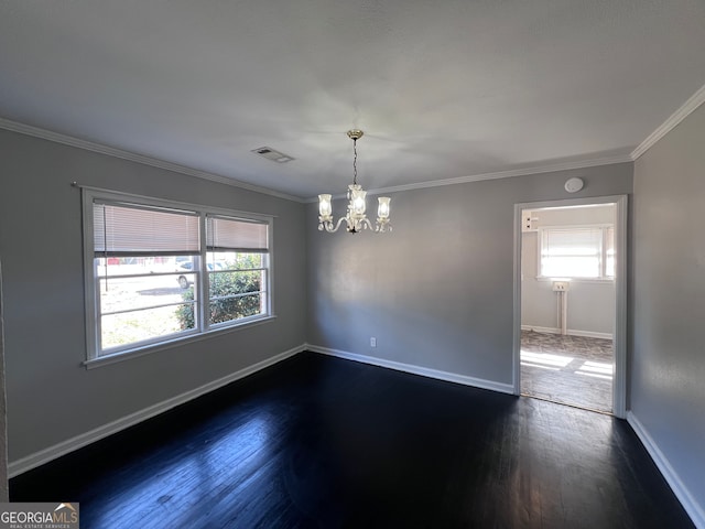 empty room featuring ornamental molding, dark wood-type flooring, and an inviting chandelier