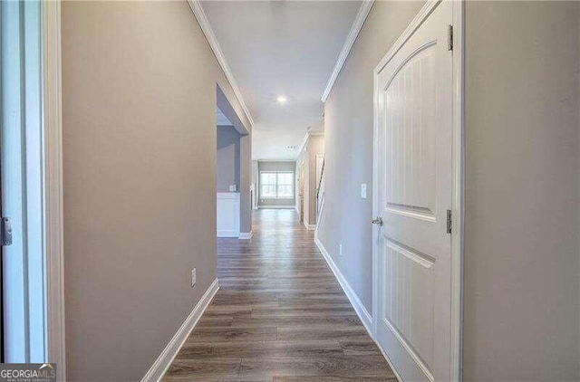 hall with dark hardwood / wood-style flooring and ornamental molding