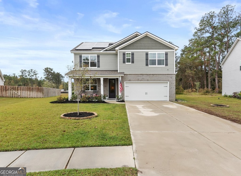 view of front of home with solar panels, a front yard, and a garage