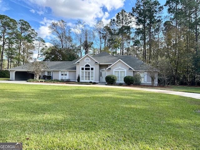 ranch-style house with a garage and a front lawn