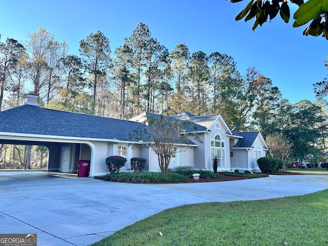 ranch-style house featuring a front lawn and a carport