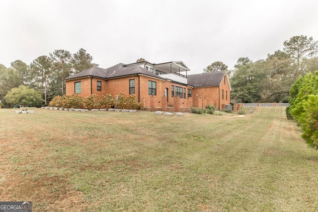 view of side of home featuring a yard