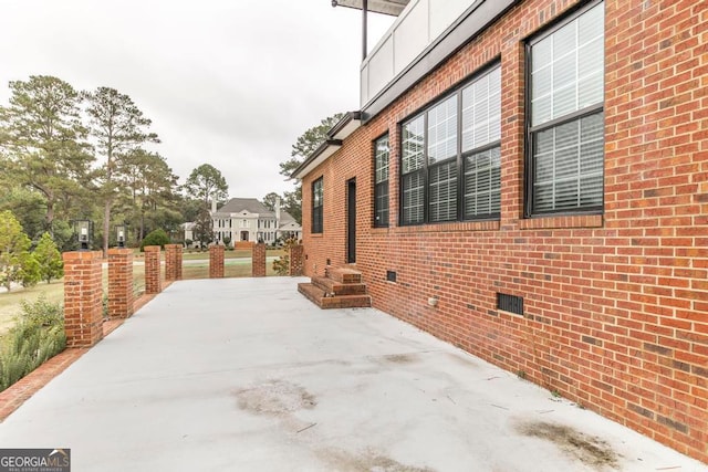 view of side of property with a patio