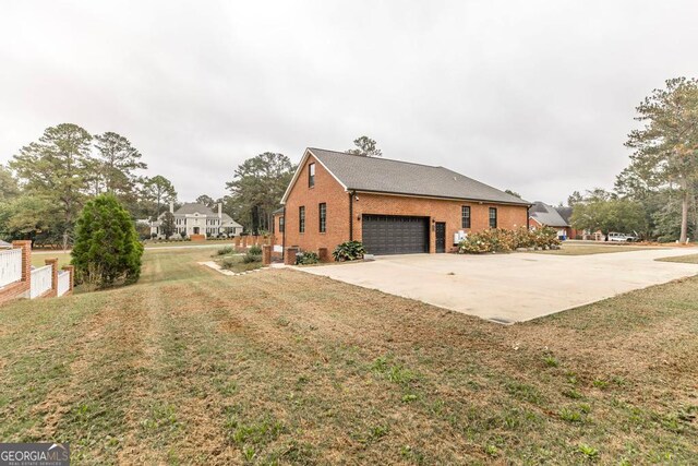 view of home's exterior with a lawn and a garage