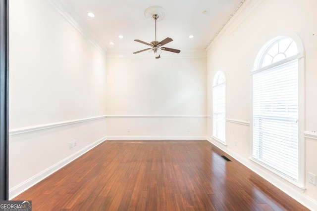 unfurnished room featuring ceiling fan, crown molding, and dark wood-type flooring