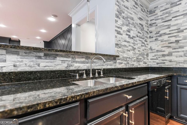 kitchen featuring backsplash, sink, and dark stone counters