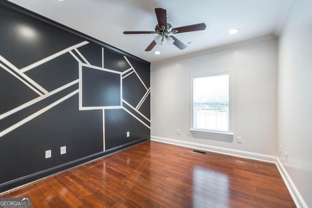 empty room featuring ceiling fan, hardwood / wood-style floors, and ornamental molding