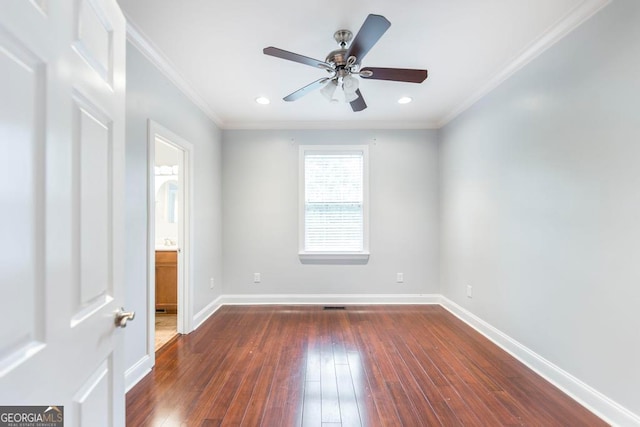 empty room featuring ceiling fan, dark hardwood / wood-style floors, and ornamental molding