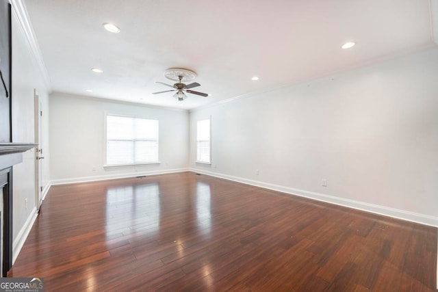 unfurnished living room with dark hardwood / wood-style flooring, ceiling fan, and crown molding