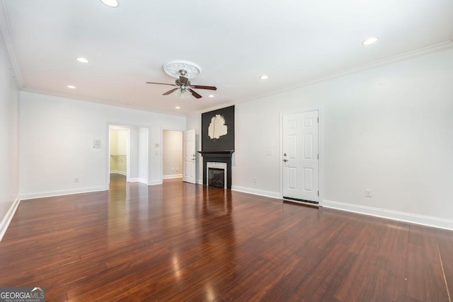 unfurnished living room featuring dark hardwood / wood-style floors, ceiling fan, and ornamental molding