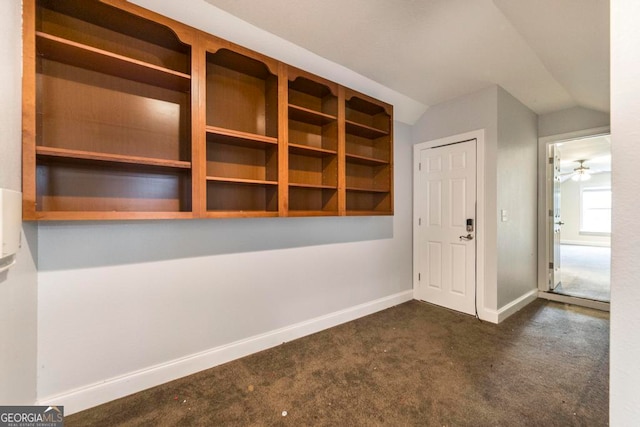 carpeted empty room with ceiling fan and lofted ceiling