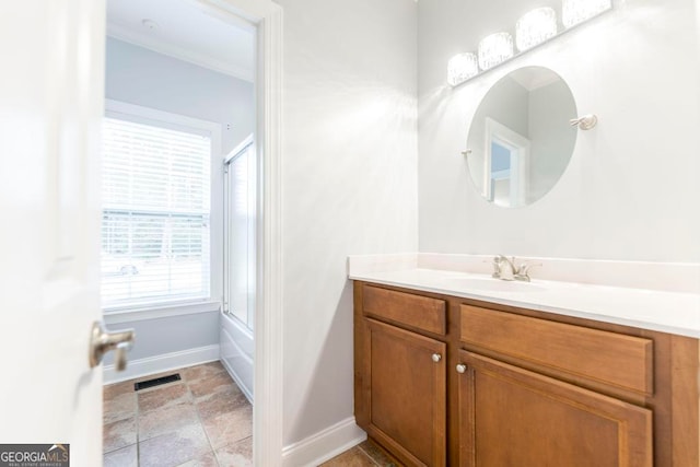 bathroom with shower / bath combination with glass door and vanity