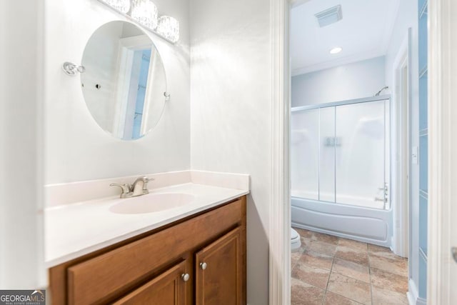 full bathroom with vanity, toilet, and bath / shower combo with glass door