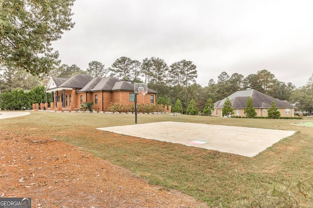 view of sport court featuring a yard