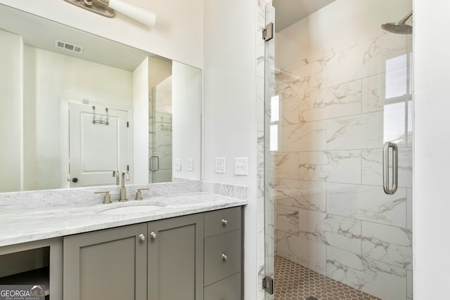 bathroom featuring vanity and a shower with shower door