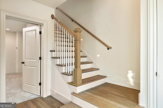 staircase featuring hardwood / wood-style flooring